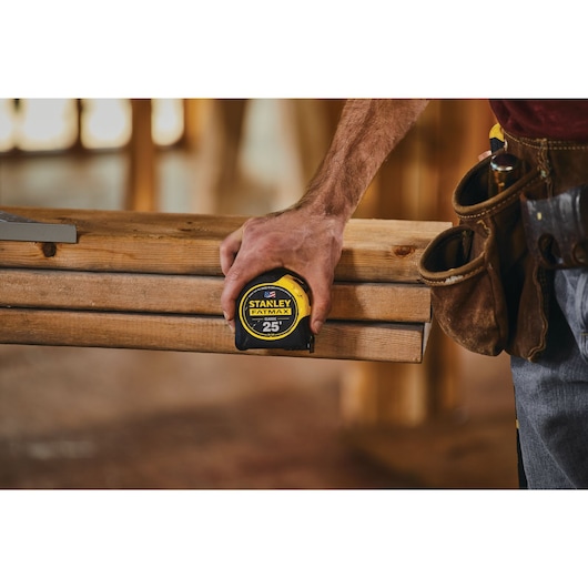 25 foot FATMAX classic tape measure being used by a person.
