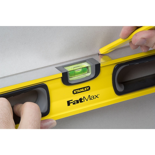 24 inch non magnetic level being used to mark.