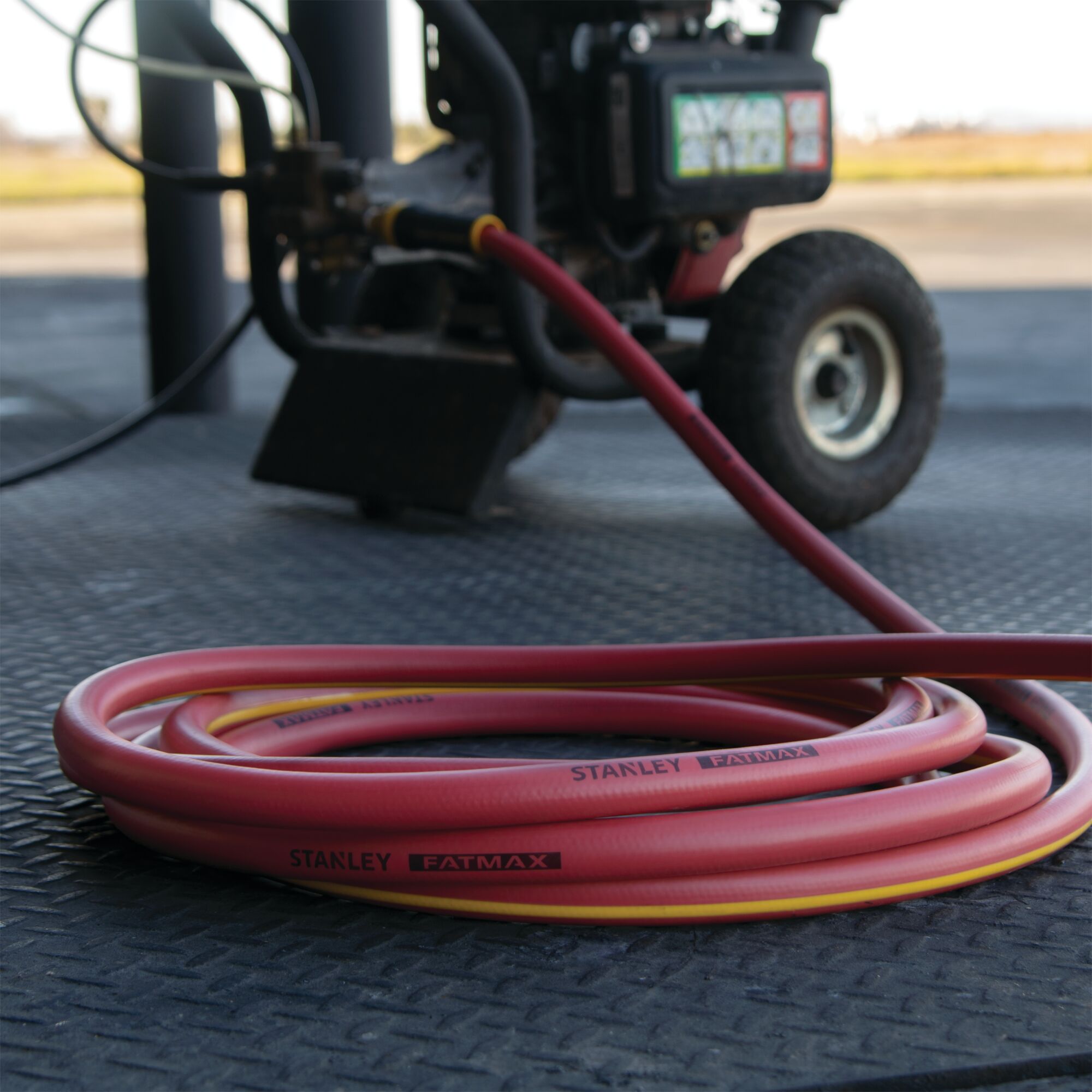 Fatmax polyfusion hot water hose in packaging placed in workplace.