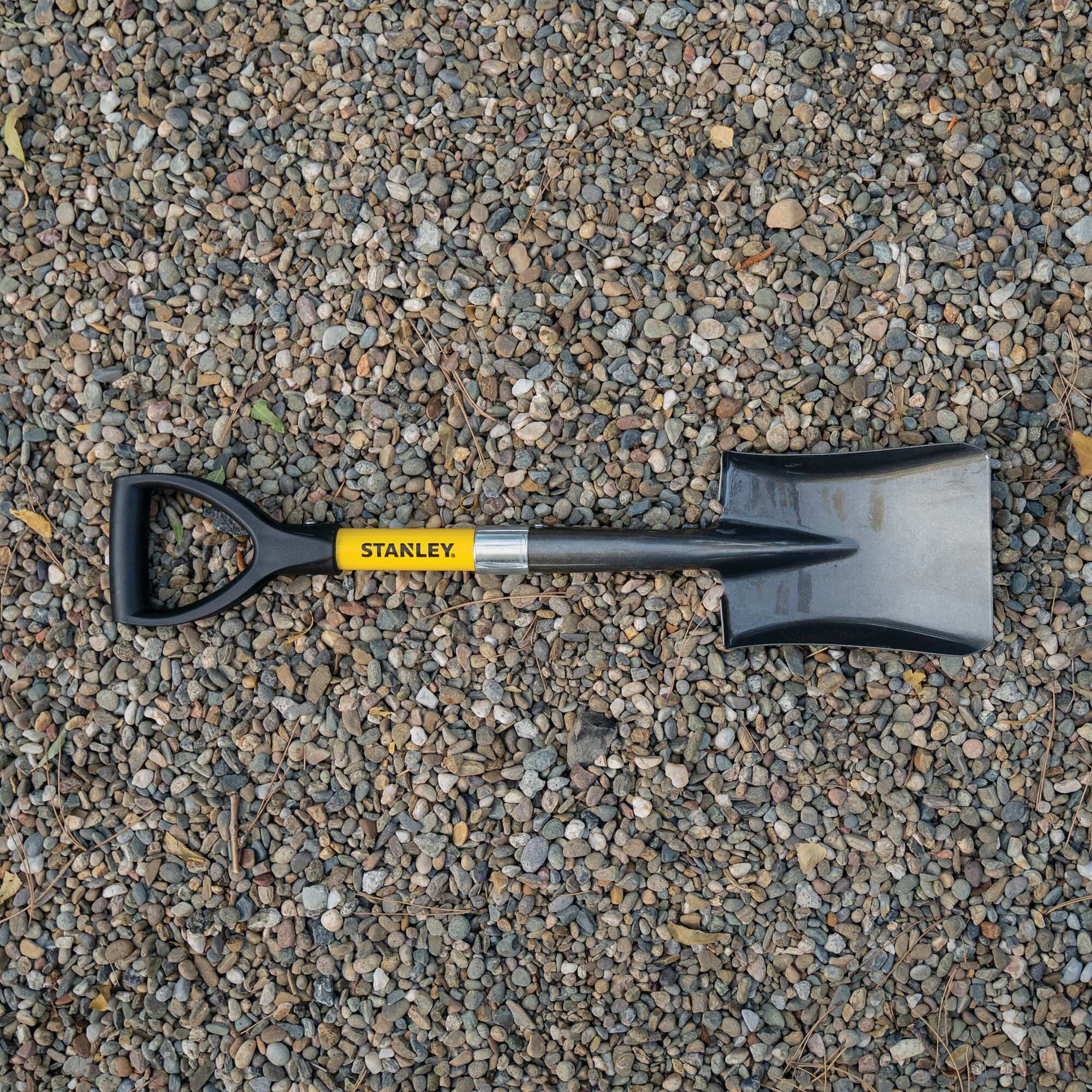Mini D square head shovel placed on granulated materials.