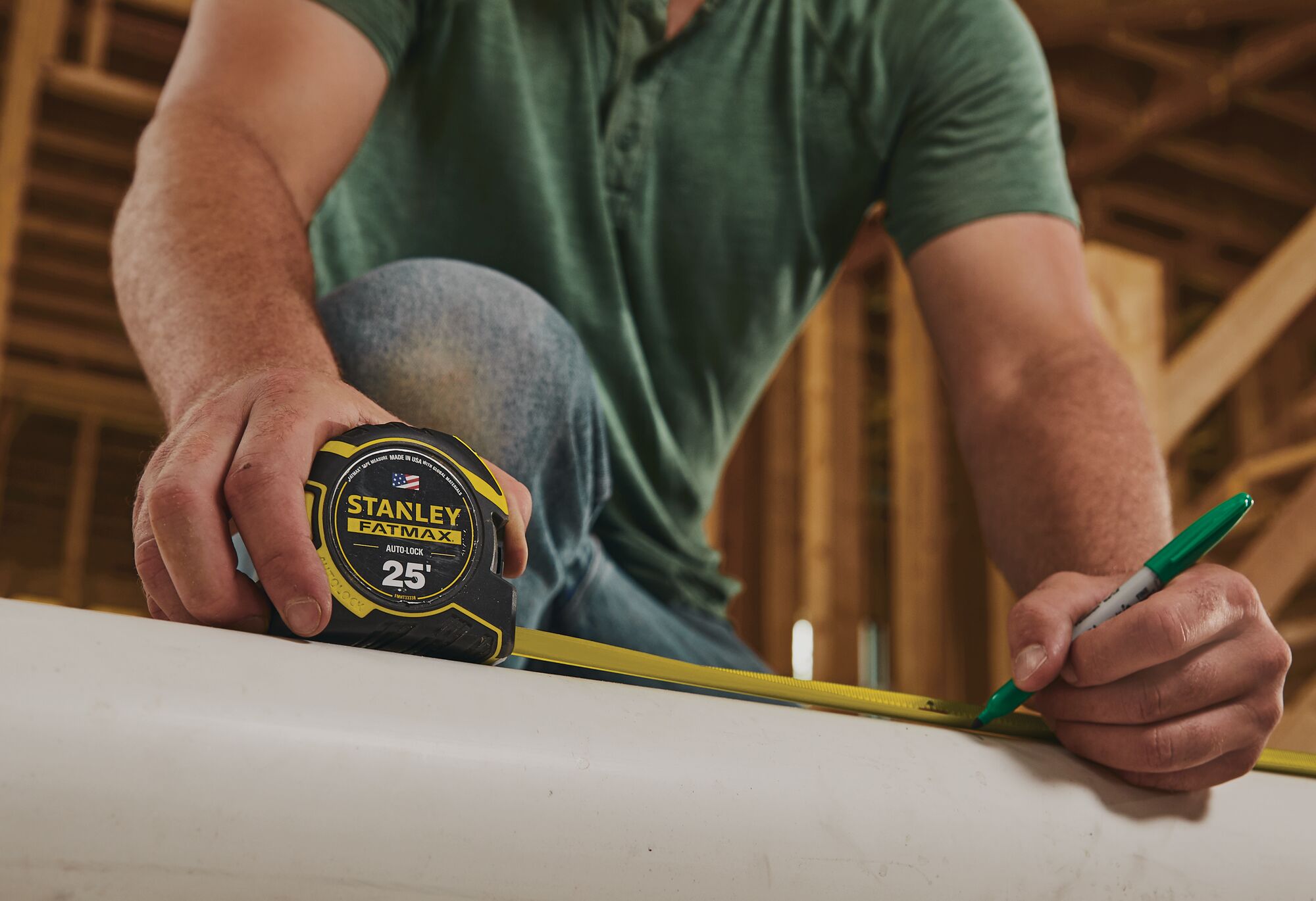 25 feet fatmax auto lock tape being used to measure a wooden table.