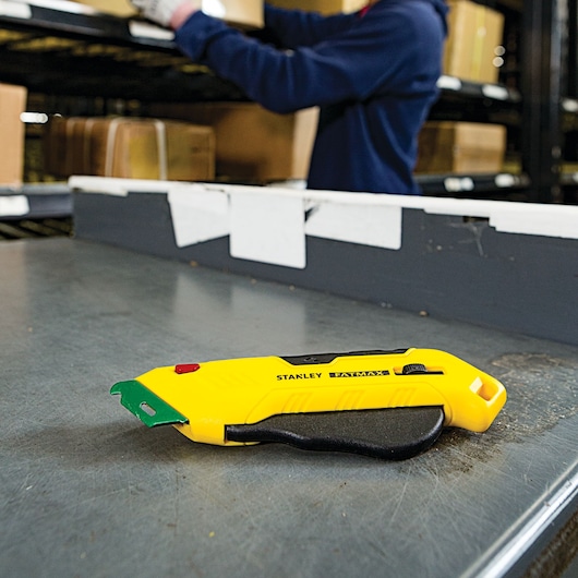Fatmax right handed box top safety knife placed on a metal table.