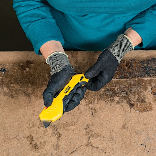 Fatmax auto retract squeeze safety knife in a person's hand.